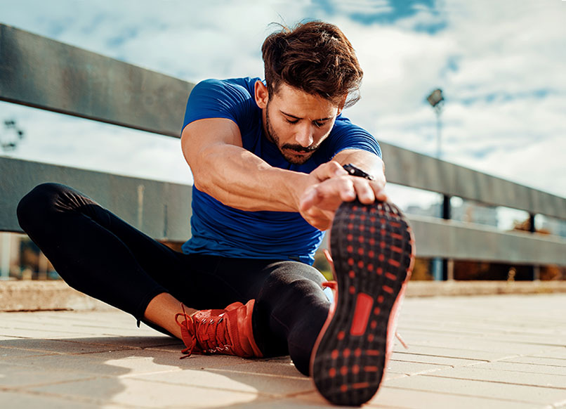 man showing his flexibility after motion preservation surgery with dr. laurence mcentee